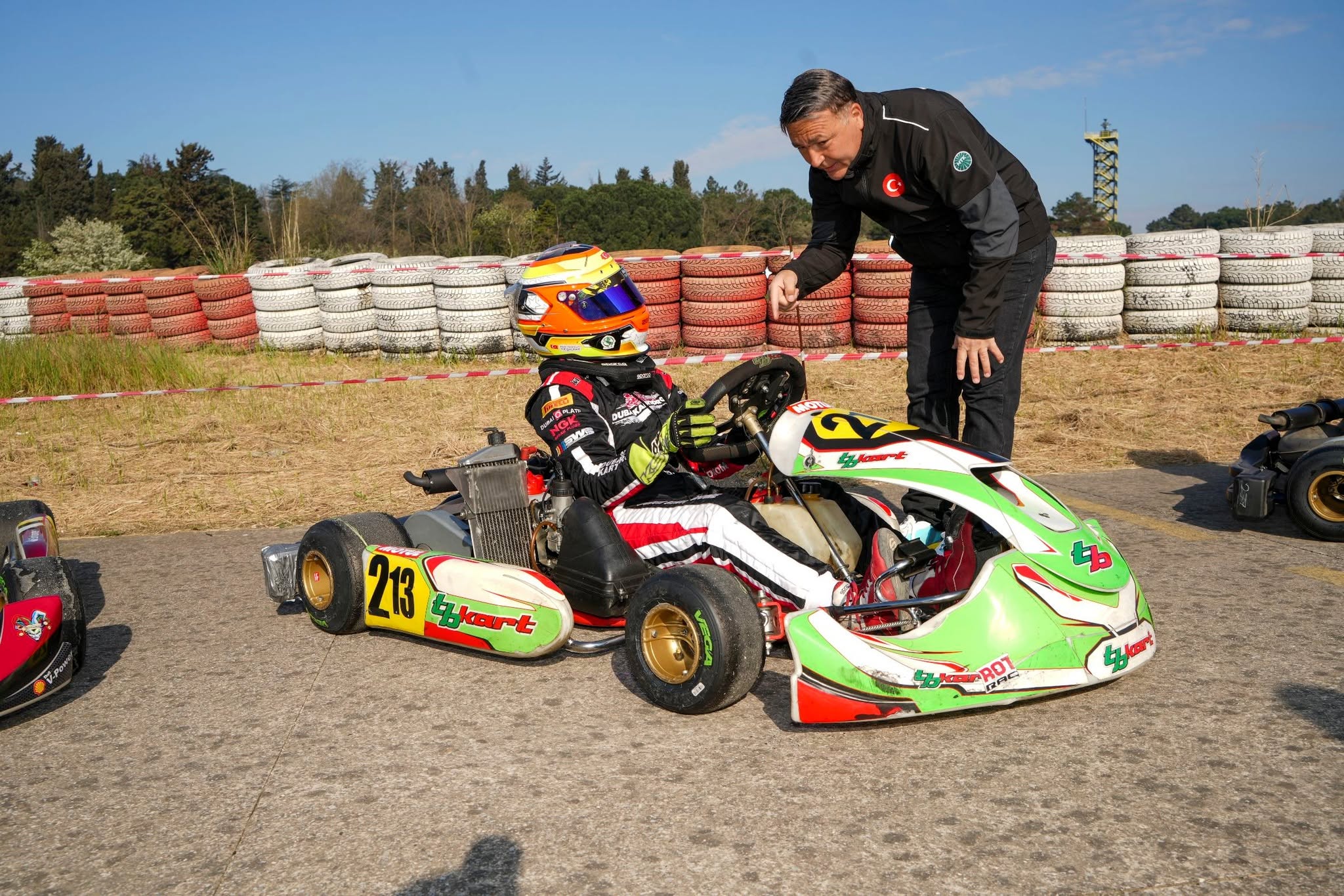 Mehmet Yaman coaching a young kart driver