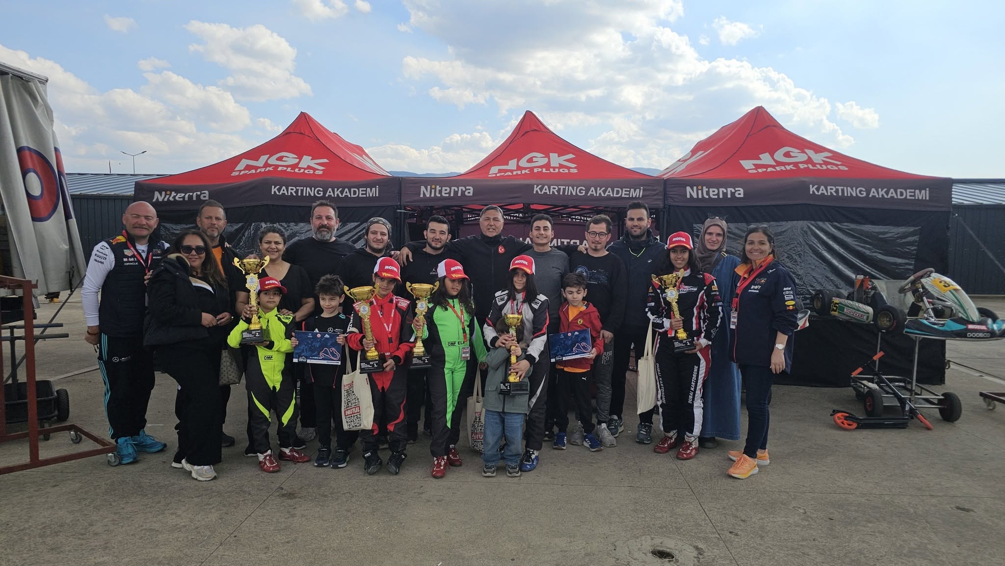 Young karting drivers and their team after a race